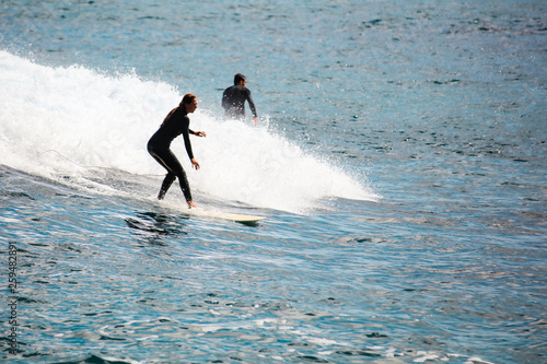 Summer time on beach and surfer on board. Sea and beach and vacation and active lifestyle concept.