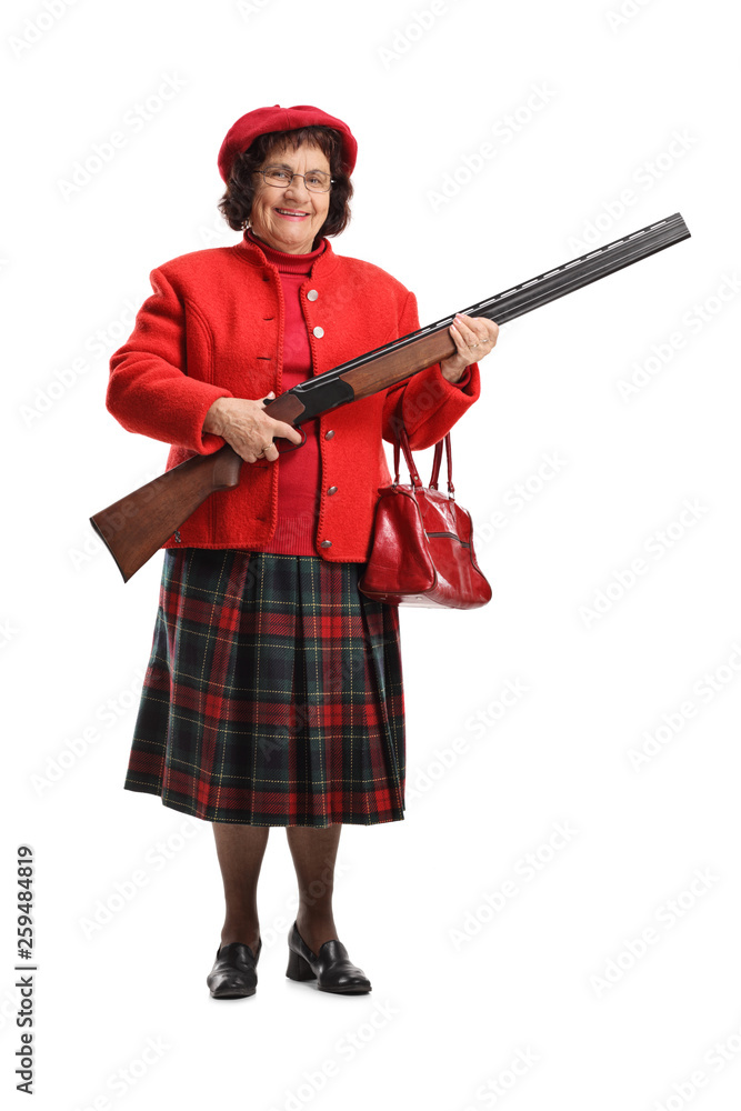 Senior lady smiling and holding a shotgun Senior lady smiling and holding a shotgun