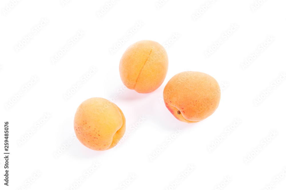 Several of harvested apricots whole and halved on white background.. Several of harvested apricots whole and halved on white background..