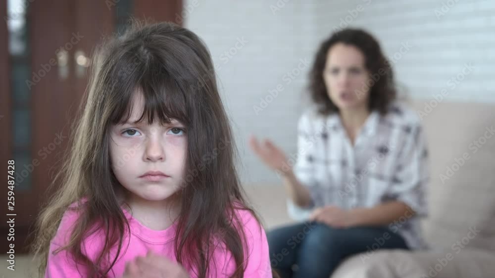 Disagreement with parents. Mother screams at little sad daughter. Disagreement with parents. Mother screams at little sad daughter.