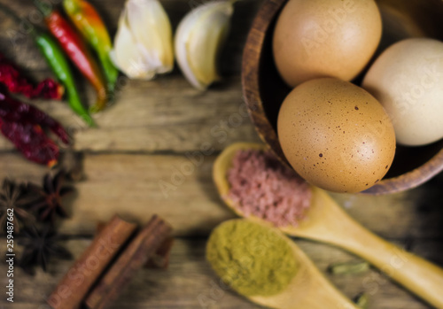 Close up of various asian spices and common ingredients on wooden board.