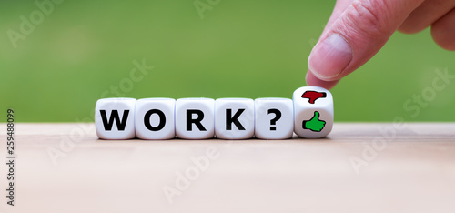 Symbol about job satisfaction. Dice form the word "work" and a hand turns a dice and changes a thumbs down symbol to a thumbs up symbol.
