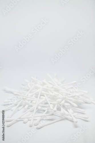 Vertical banner with cotton buds heap isolated on the white copy space background