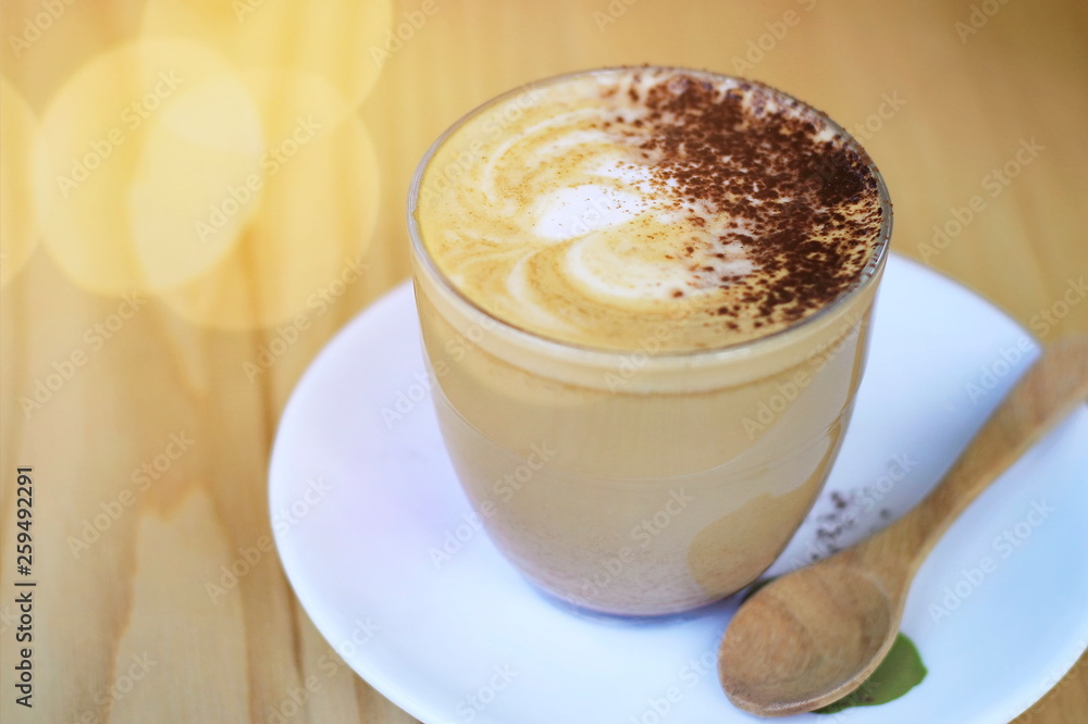 Hot latte coffee on the table with blurred bokeh background. Hot latte coffee on the table with blurred bokeh background.