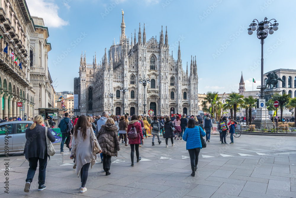 Naklejka premium Milan, Italy - March 8, 2019: Milan Cathedral from the square with tourists, Italy