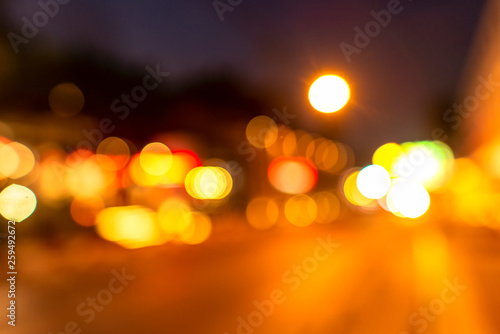 Night twilight blurred light gold bokeh reflecting on the sea surface water abstract background.
