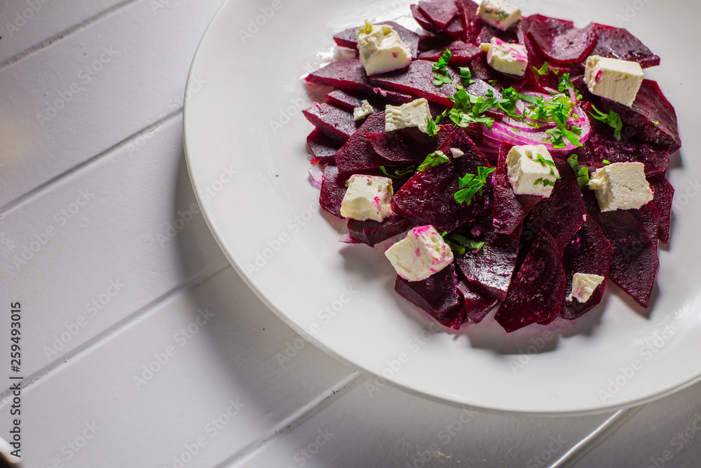 Vitamin salad with beets and Feta cheese in a white plate Vitamin salad with beets and Feta cheese in a white plate