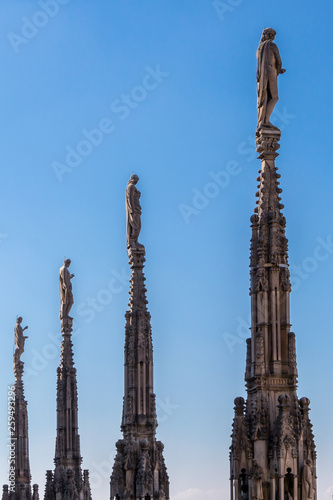 The beautiful Gothic cathedral roof terraces with stone statues on the spires