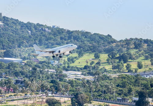 White commercial airplane flying take off from runway at Samui Airport, Samui island, Surat Thani, Thailand travel destinations concept. photo