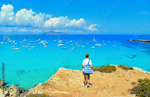 beach Cala Rossa on Favignana Island with small boats and Island Marettimo in background, Sicily Italy photo