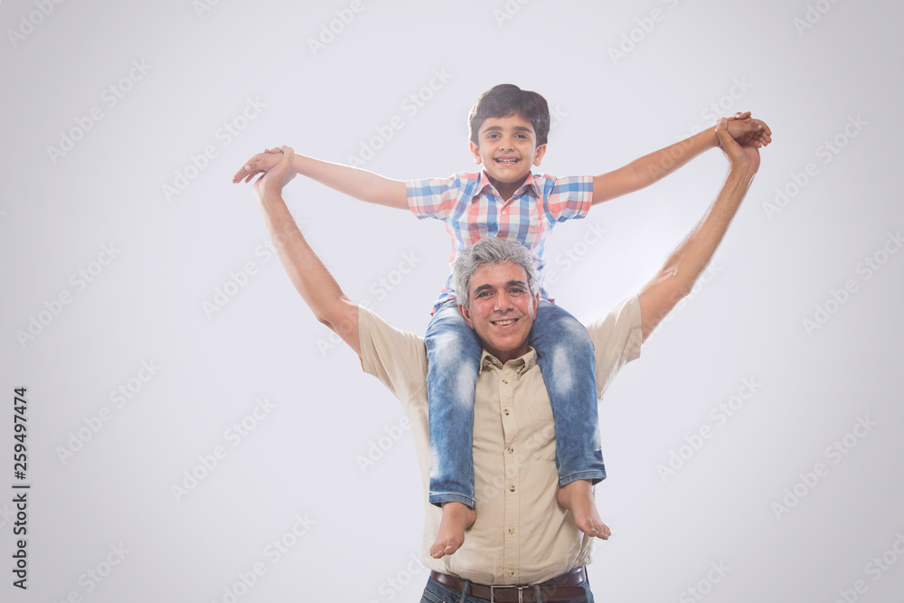 Grandfather carrying grandson on shoulders Grandfather carrying grandson on shoulders