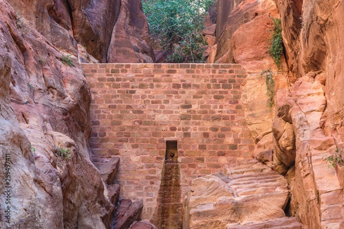 Dam in Siq passage in ancient Petra city in Jordan photo