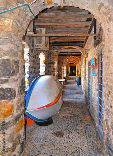 old stone archade with fishing boats in the historic medieval center of Tellaro village in Liguria photo