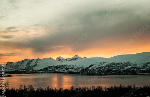 Tromso Tromsø massive huge mountains in sunset evening light. View to Kvaløysletta © Anna
