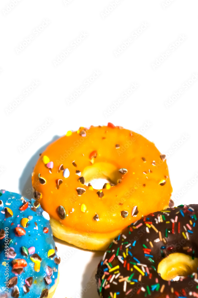 Sweet tasty donuts with colorful sprinkles isolated on white background
