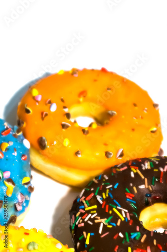 Sweet tasty donuts with colorful sprinkles isolated on white background