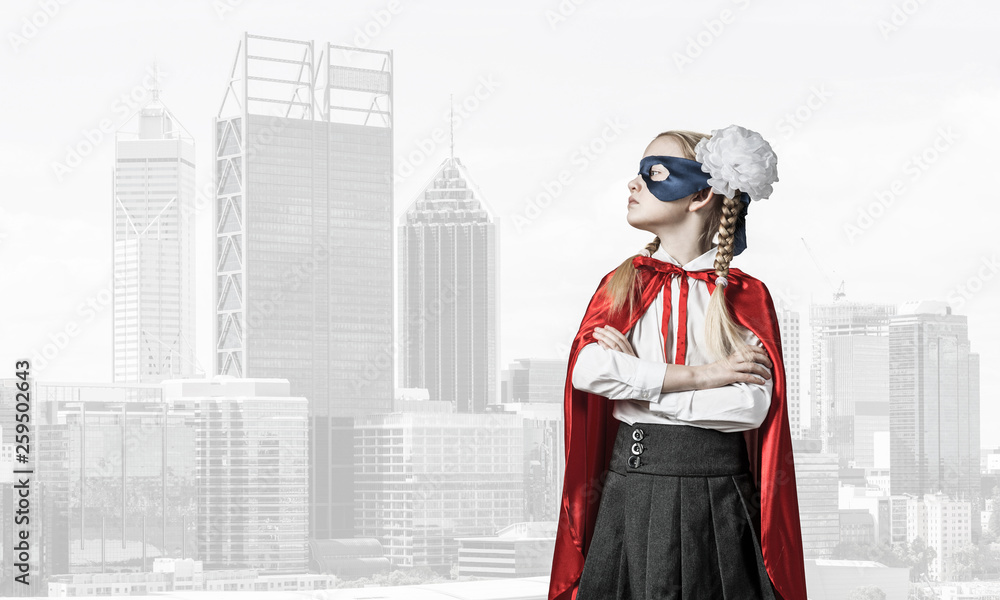 Girl power concept with cute kid guardian against cityscape background