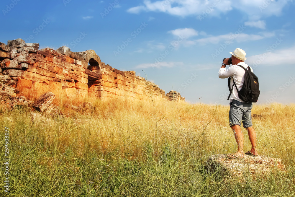 Photographing attractions . man photographs the ruins of the ancient city . Hierapolis . Turkey.