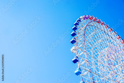 Closeup and crop Tempozan Giant Ferris Wheel on bright blue sky background with space for texts. photo