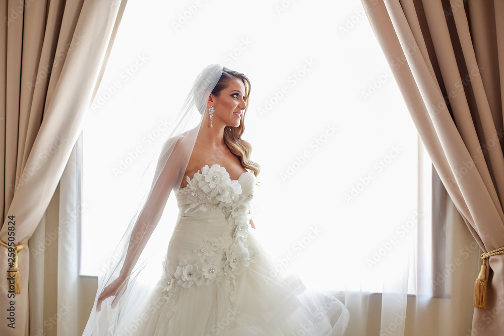 Beautiful bride posing indoor on her wedding day Beautiful bride posing indoor on her wedding day