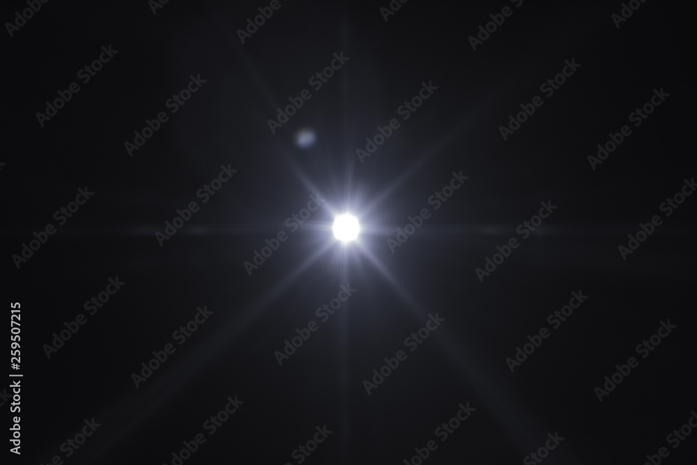 Single spark on black background. Lens flare effect. Defocused rays and lights. Single spark on black background. Lens flare effect. Defocused rays and lights.
