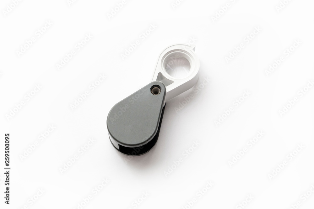 Magnifying glass for diamonds or see the amulet Isolated on a White Background. Magnifying glass for diamonds or see the amulet Isolated on a White Background.