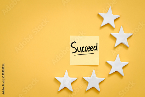 Personal and business success. Growth and development. Aim and objective to work. Succeed memo and stars. Copy space.