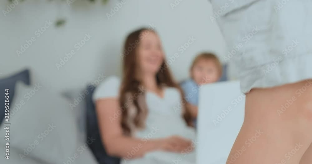 Mother with kids playing on laptop computer Mother with kids playing on laptop computer