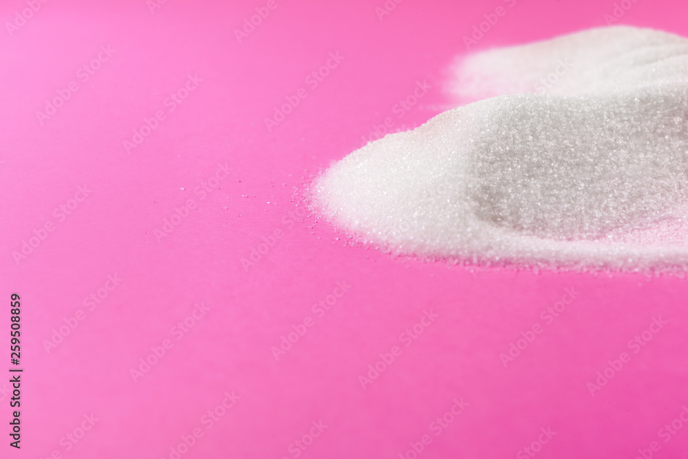 Fototapeta premium White sugar on a pink background top view