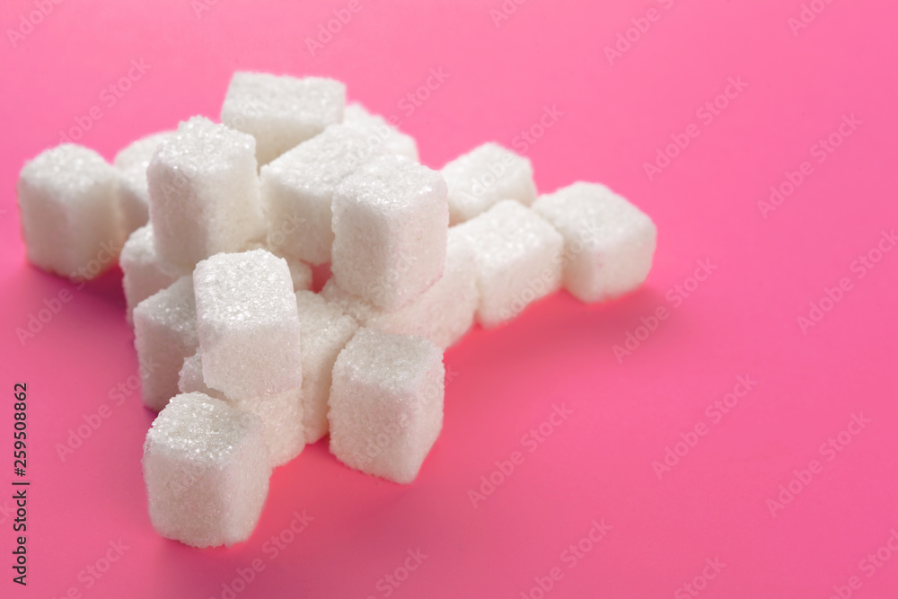 Cubes of sugar on a pink background. Empty space for copying text Cubes of sugar on a pink background. Empty space for copying text
