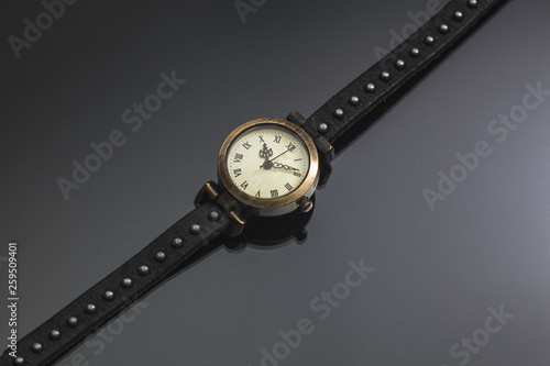 wristwatches on a gray background, subject shooting, vintage old watches in inheritance, women's watches, vintage arrows, reflected on the background