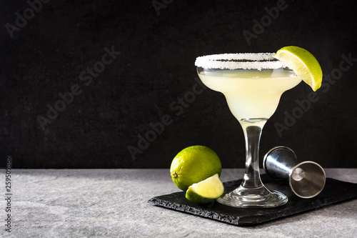 Margarita cocktails with lime in glass on gray background. Copyspace photo