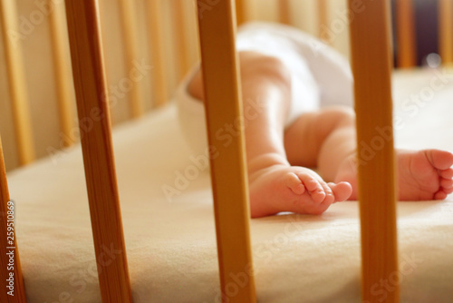 Infant baby is sleeping in his crib. Importance of sleep for babies. Sleep mode babies 3 months.