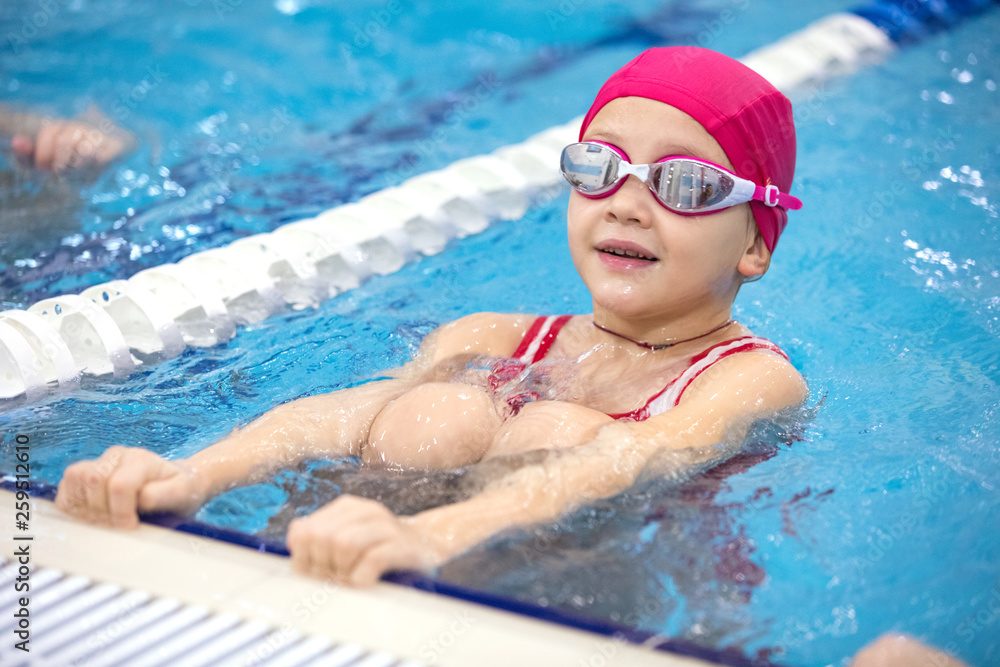little girl swimming  in pool