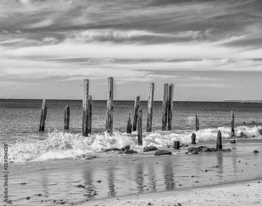 Old wooden pier posts at Port Willunga beach, Adelaid, South Australia