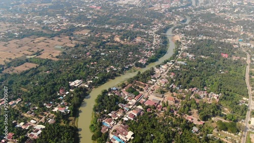 Aerial clip of the muddy waters of Sangkae River in Battambang Cambodia during a summer day photo