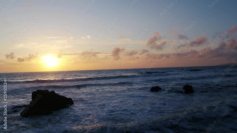 Journey to the sun setting on a Northern California Beach, Sun Rays highlight the surf breaking on weather stone. Journey to the sun setting on a Northern California Beach, Sun Rays highlight the surf breaking on weather stone.