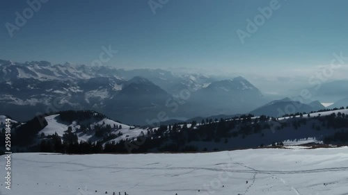 A drone movie with a scenic view to the snowy swiss alps and the lake of lucerne. photo