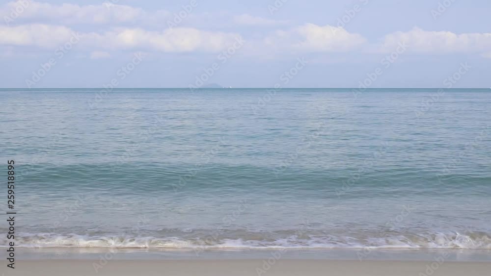 Front view of tropical sand beach with waves and sky Front view of tropical sand beach with waves and sky