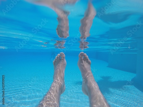 Feet in swimming pool underwater © StockPhotoAstur