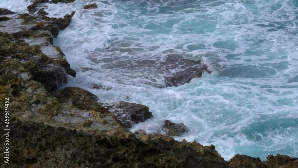 Closeup shot of waves crashing into a rocky shoreline Closeup shot of waves crashing into a rocky shoreline
