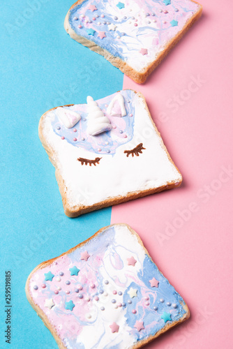 Colorful Unicorn toasts with stars, food for kids idea, blue and pink background