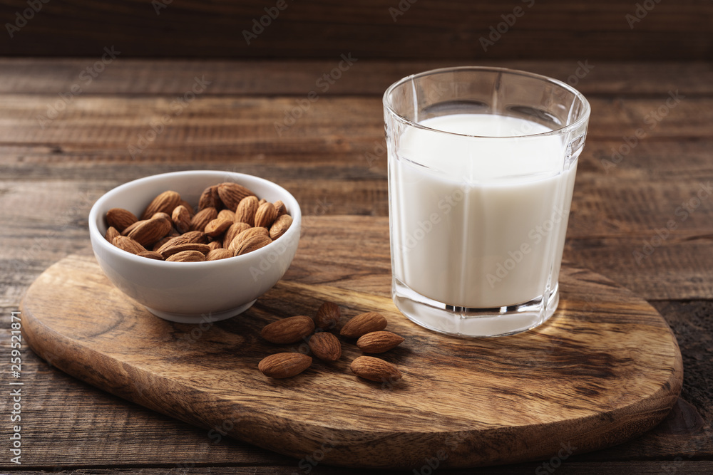 close up almond milk on wooden natural background close up almond milk on wooden natural background
