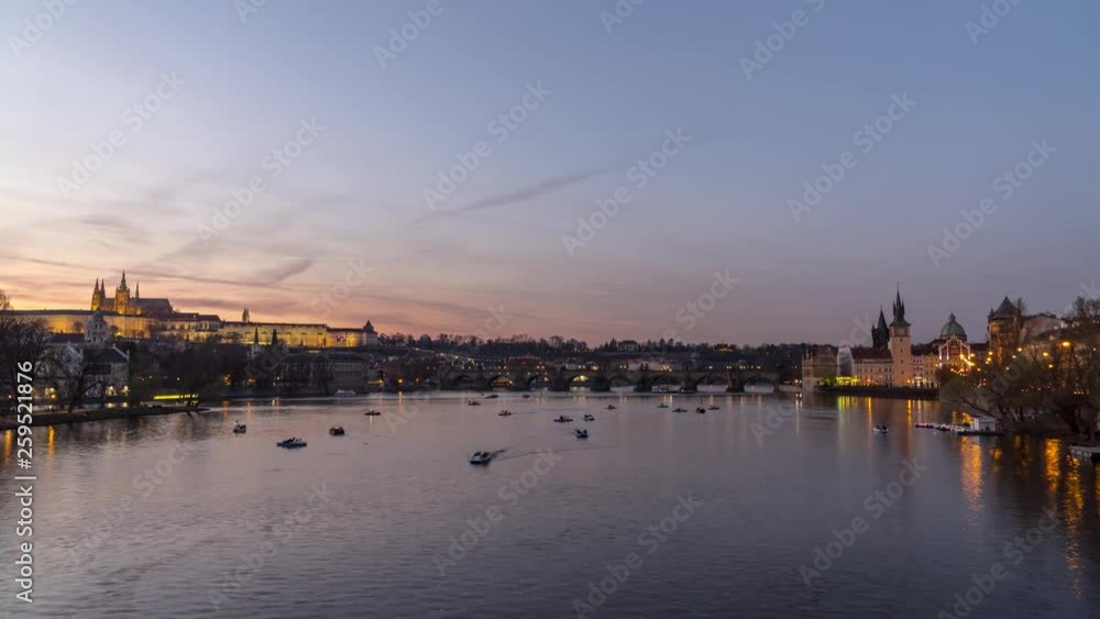 4K timelapse of paddle boats on Vltava river in Prague with castle and Charles Bridge in the background, zoom in view 4K timelapse of paddle boats on Vltava river in Prague with castle and Charles Bridge in the background, zoom in view