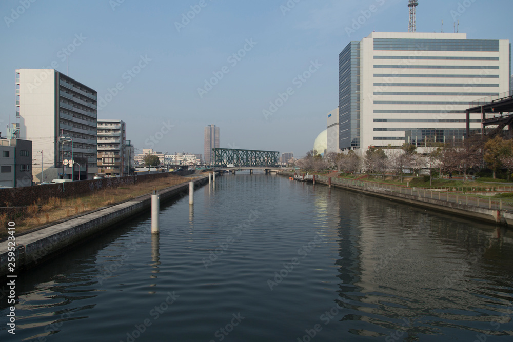 Cityscape with river, bridges and buildings in Osaka in spring clear day