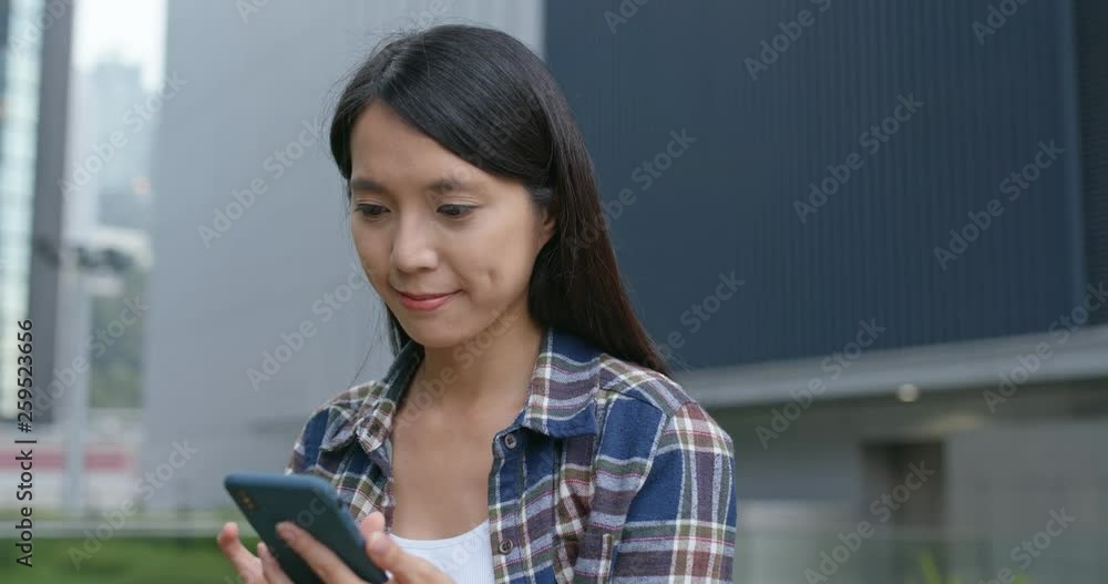Woman check on cellphone in city Woman check on cellphone in city