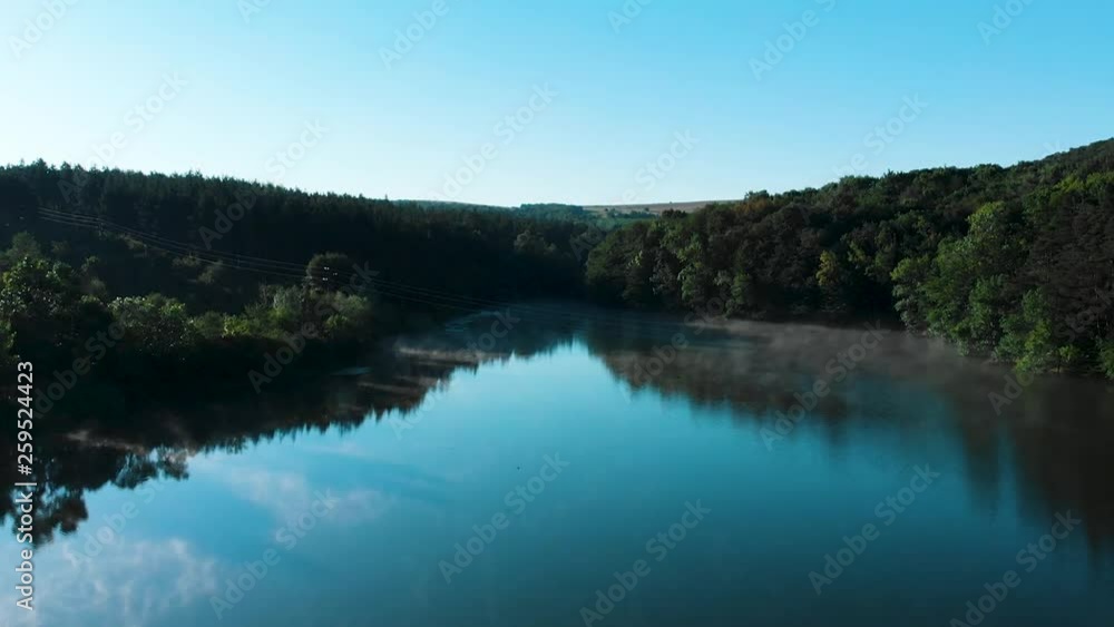 Early morning aerial shot over glossy lake with birds Early morning aerial shot over glossy lake with birds