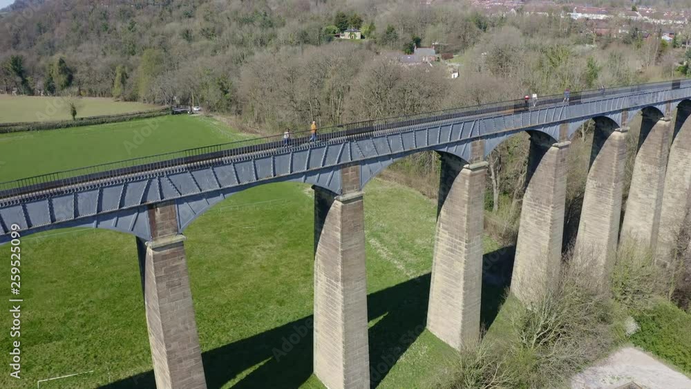 People walk across the beautiful Narrow Boat canal route called the Pontcysyllte Aqueduct famously designed by Thomas Telford, located in the beautiful Welsh countryside, A huge bridge viaduct People walk across the beautiful Narrow Boat canal route called the Pontcysyllte Aqueduct famously designed by Thomas Telford, located in the beautiful Welsh countryside, A huge bridge viaduct