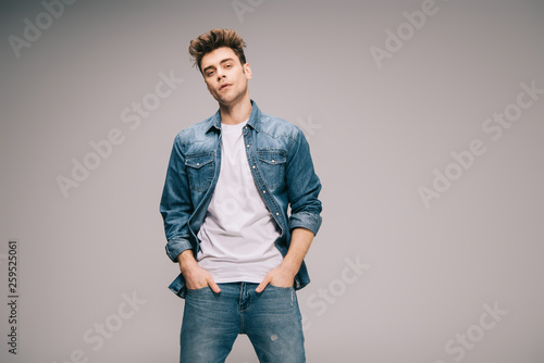 handsome and good-looking man in jeans, skirt and t-shirt with hands in pockets © LIGHTFIELD STUDIOS