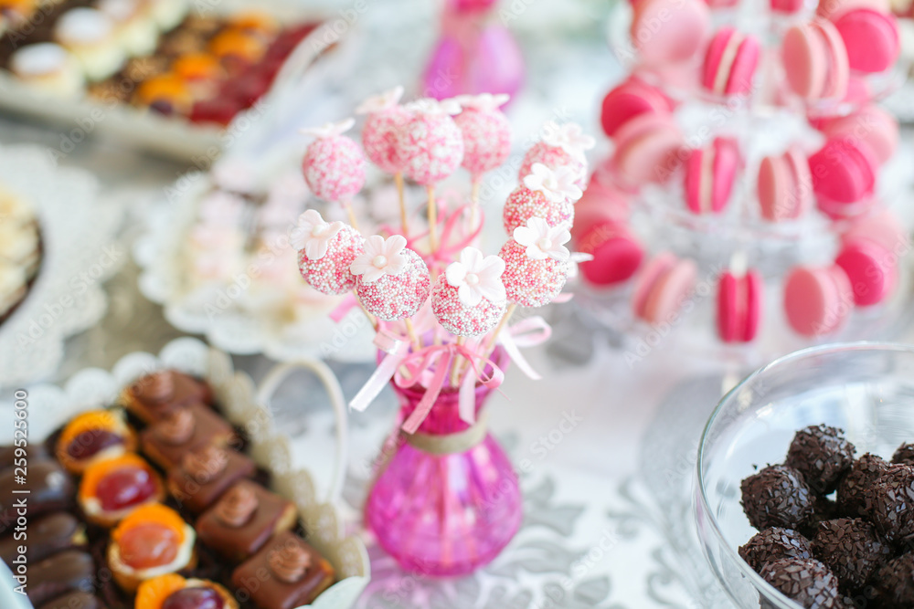 Delicious candy bar with cupcakes, cake pops and other sweets Delicious candy bar with cupcakes, cake pops and other sweets